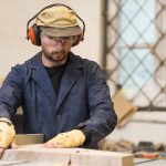 male-carpenter-placing-wooden-blocks-workshop
