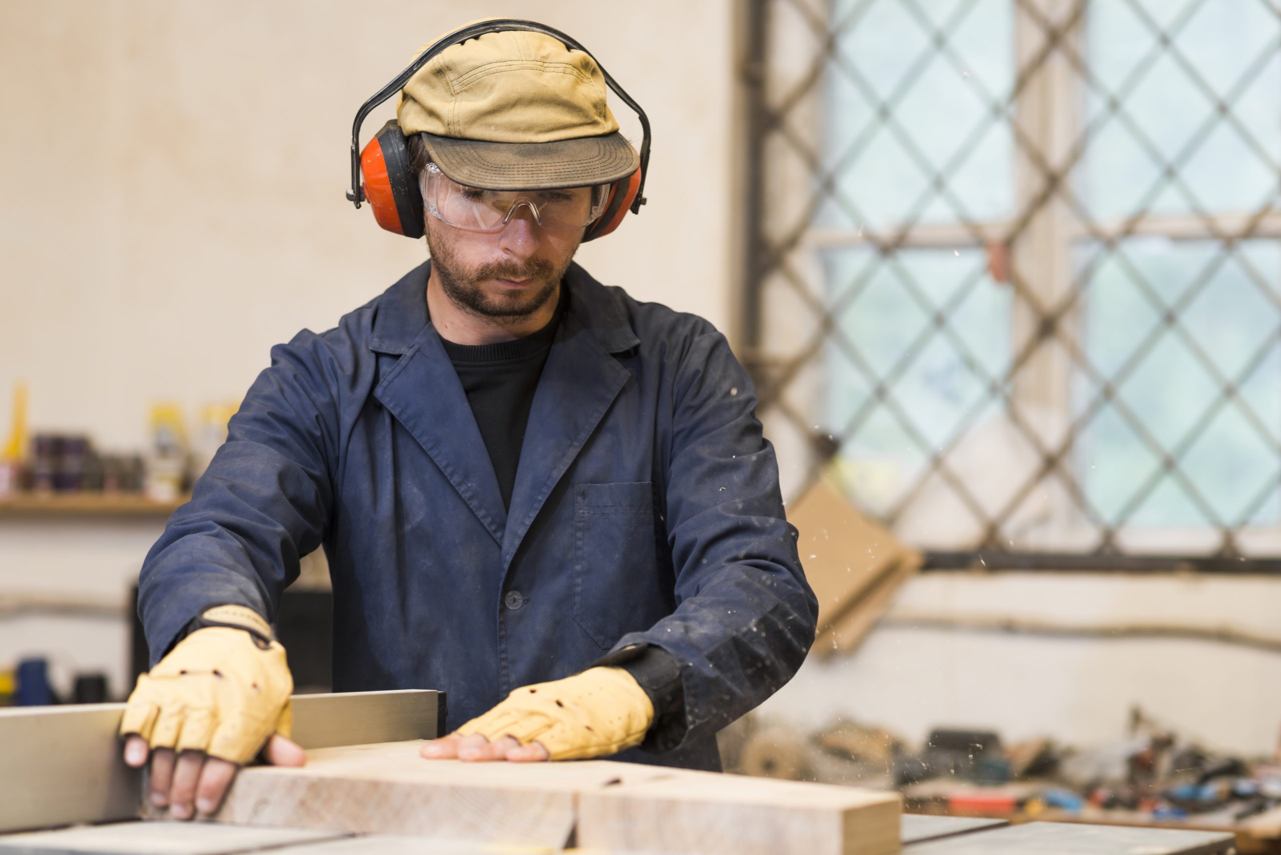 male-carpenter-placing-wooden-blocks-workshop